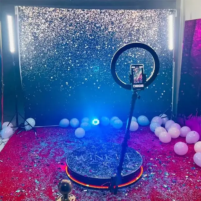 Confetti backdrop with a 360 photo booth platform at a Jaipur event