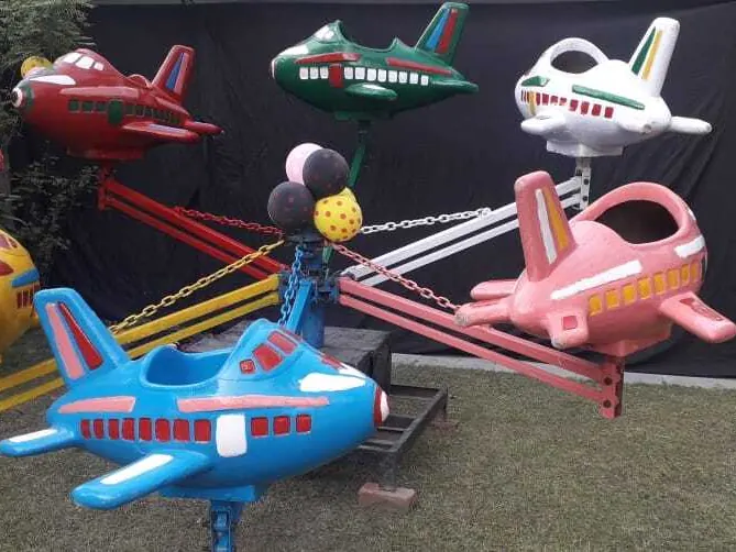 Children enjoying an aeroplane merry-go-round ride