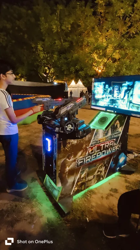 Guest playing the alien shooter arcade game during a Mumbai celebration