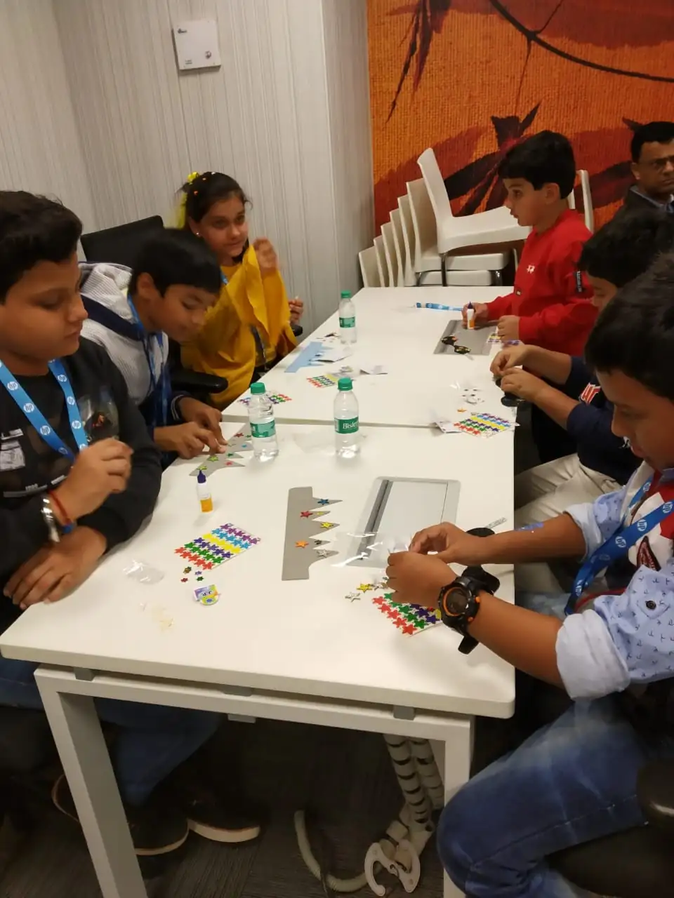 Children creating colourful crafts at an event activity table