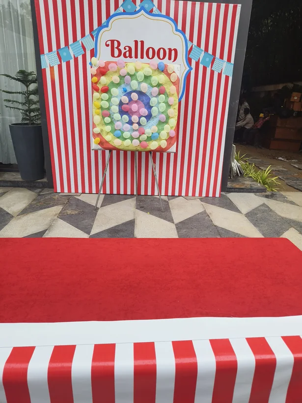 Balloon shooting game with striped event backdrop prepared in Kanpur
