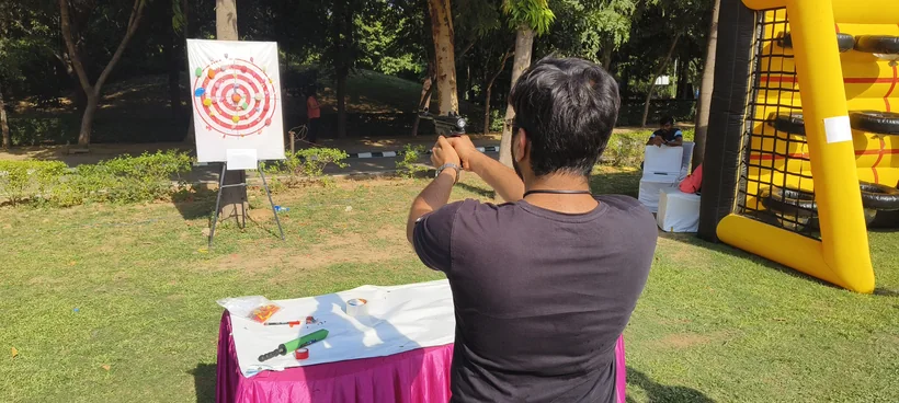 Outdoor balloon shooting activity set up for a celebration in Kanpur