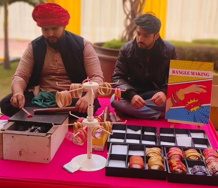 Live bangle making artist preparing bangles at an event counter