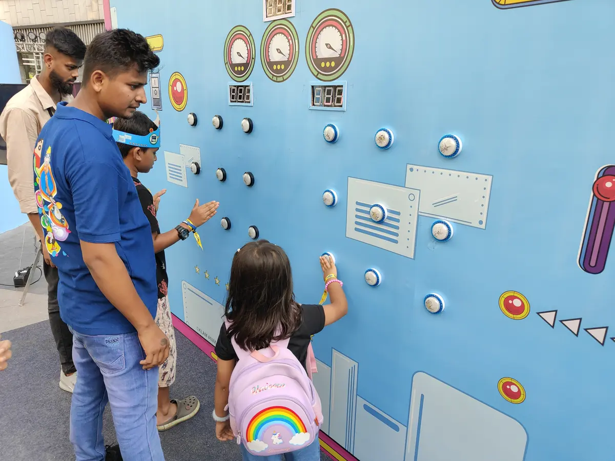 Children using a supervised Batak reaction wall at a Mumbai event