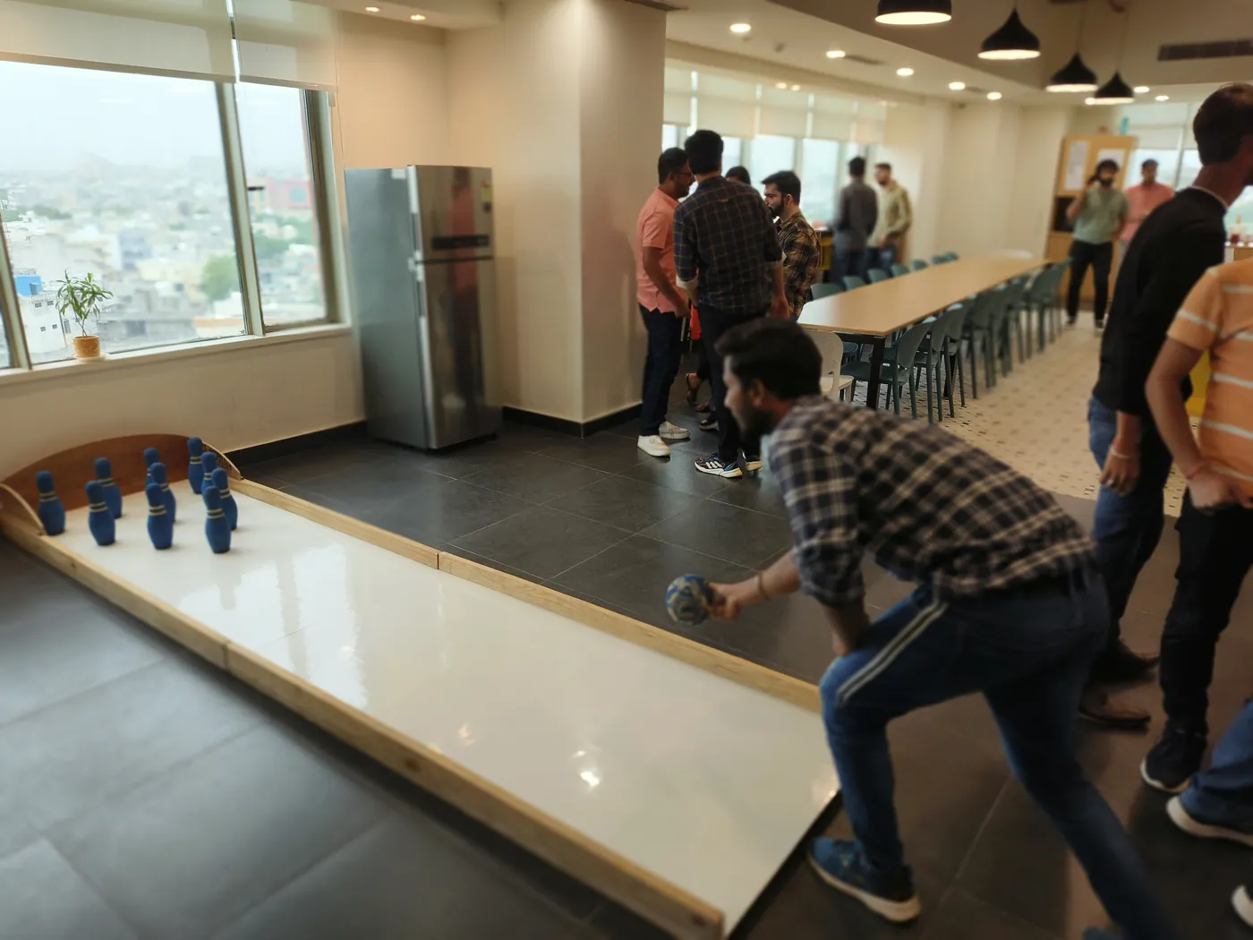 Guests participating in a portable bowling activity at a corporate event