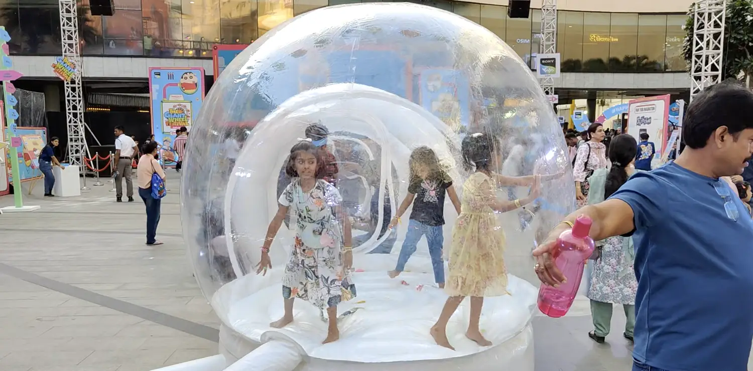 Children enjoying a supervised inflatable bubble house activity