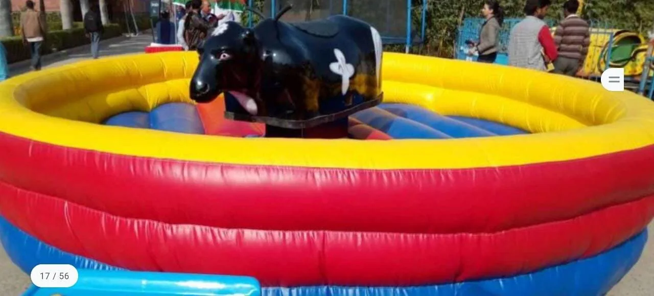 Classic mechanical bull inside a colourful inflatable safety bed