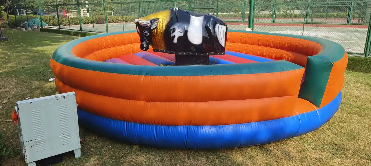 Mechanical bull ride with a large inflatable safety arena for an outdoor Mumbai event