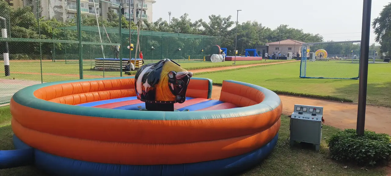 Mechanical bull and inflatable arena prepared for a large outdoor event