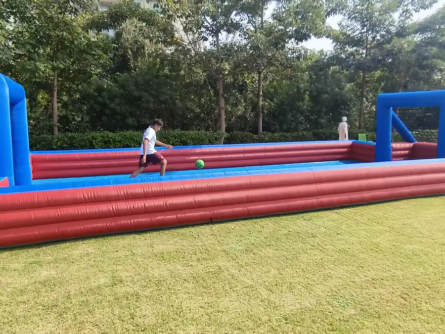 Guests enjoying slippery football game during a Mumbai celebration