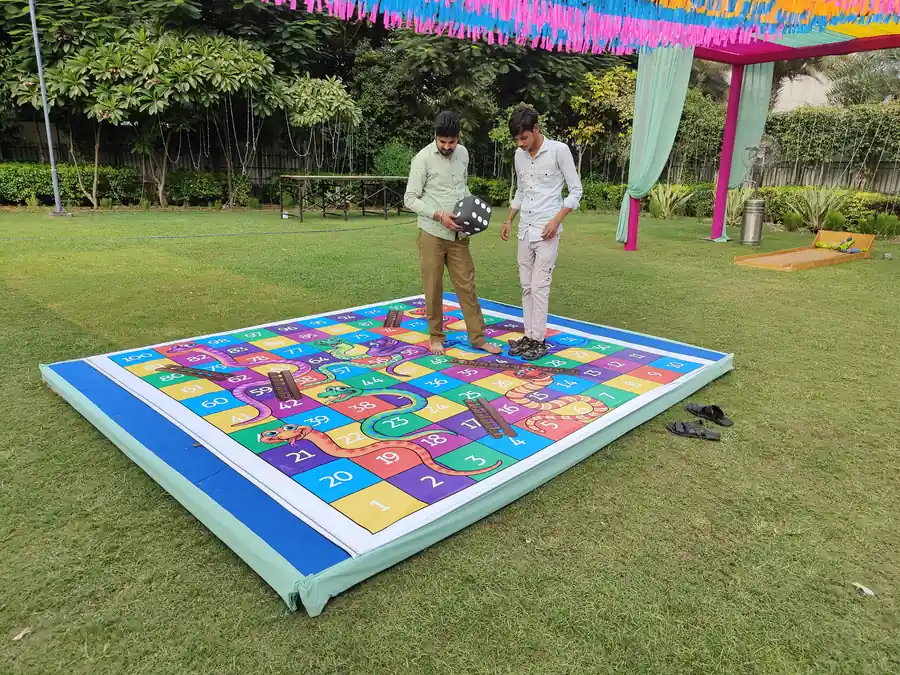Guests enjoying snake and ladder game during a Mumbai celebration