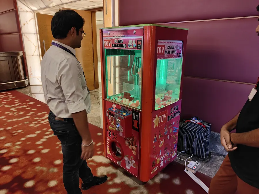 Guests enjoying toy claw machine during a Mumbai celebration