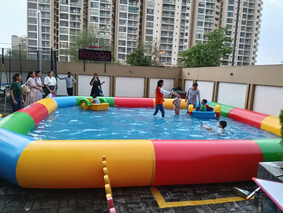 Guests enjoying water pool party game during a Mumbai celebration